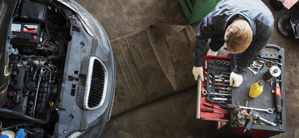 top-view-man-repairing-car